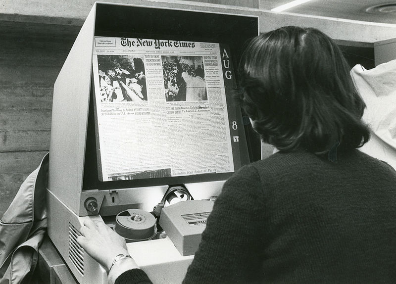 Woman using microfilm reader